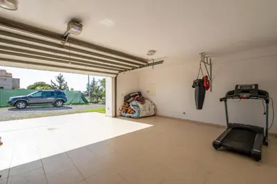 a room with a treadmill and a car parked in a garage at Superb Villa in Bouznika with Private Pool & Hammam in Bouznika