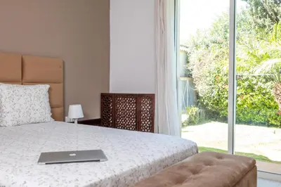 a bedroom with a bed with a laptop on it at Superb Villa in Bouznika with Private Pool & Hammam in Bouznika