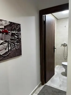 a bathroom with a picture of a bike on the wall at Skyline Urban - by Nero in Casablanca
