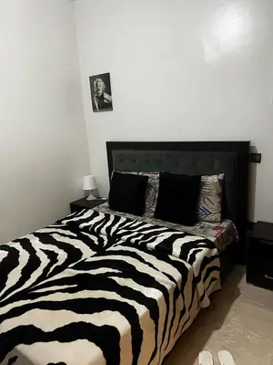 a black and white zebra print bed in a bedroom at Zen Haven - by Nero in Casablanca