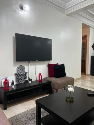 a living room with a couch and a tv on the wall at Zen Haven - by Nero in Casablanca