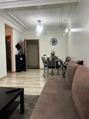 a living room with a couch and a table and a clock at Zen Haven - by Nero in Casablanca