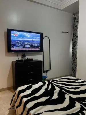 a bedroom with a flat screen tv and a bed at Zen Haven - by Nero in Casablanca
