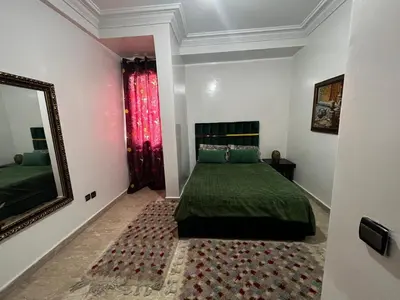a bedroom with a green bed and a mirror at Pure Space - by Nero in Casablanca