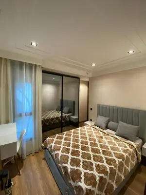 a bedroom with a large bed and a desk and a desk at Appart youssef in Casablanca
