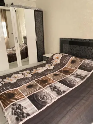 a bedroom with a bed with a large mirror at Jnane in Sidi Rahal