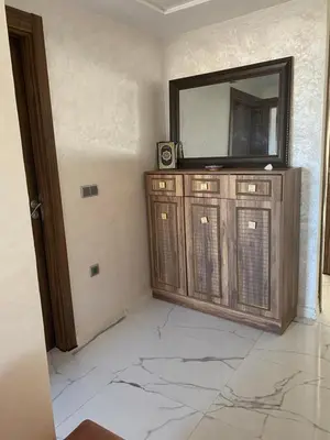 a room with a mirror and a television on a wall at Jnane in Sidi Rahal