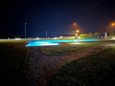 a skate park lit up at night with blue lights at Appartement à Dar bouaaza in Tamaris