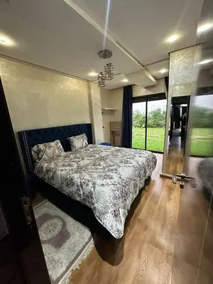 a bedroom with a bed and a large window at Appartement à Dar bouaaza in Tamaris