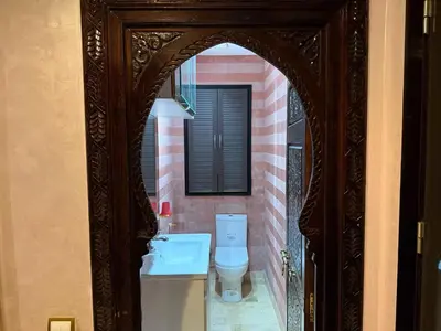 a bathroom with a toilet and a sink at Appartement à Dar bouaaza in Tamaris