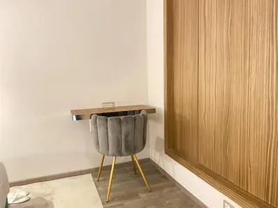 a gray chair sitting in a room with a desk at Welcome to Casablanca in Casablanca