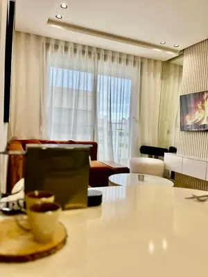 a living room with a table with a cup of coffee at Bat infinity living in Casablanca