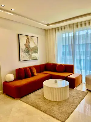 a living room with a red couch and a coffee table at Bat infinity living in Casablanca