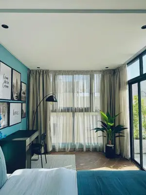 a bedroom with a bed and a desk and a window at Luxury 1-Bedroom Apartment in Maarif in Casablanca