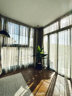 a room with large windows and a potted plant at Luxury 1-Bedroom Apartment in Maarif in Casablanca