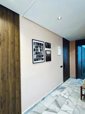 a hallway with white walls and a wooden wall at Luxury 1-Bedroom Apartment in Maarif in Casablanca