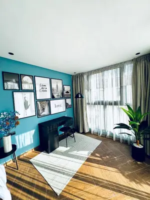 a living room with blue walls and a fireplace at Luxury 1-Bedroom Apartment in Maarif in Casablanca