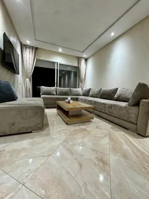 a living room with a couch and a coffee table at Ramoflores , sidi rahal in Sidi Rahal