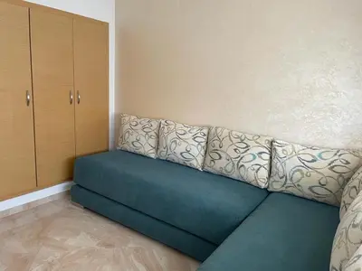 a couch sitting in the corner of a room at Ramoflores , sidi rahal in Sidi Rahal