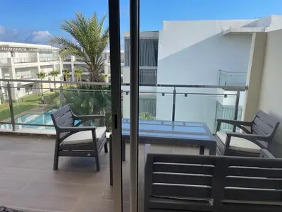 a patio with two chairs and a table on a balcony at Ramoflores , sidi rahal in Sidi Rahal