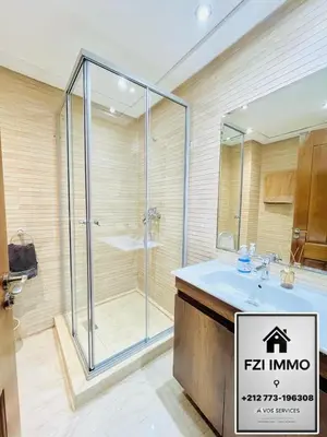 a bathroom with a glass shower and a sink at Studio journalier au centre de Casablanca in Casablanca