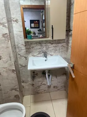 a bathroom with a sink and a toilet at appart 206 in Temara