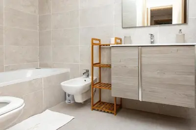 a bathroom with a sink and a toilet and a mirror at Luxurious and comfortable in Prestigia in Rabat