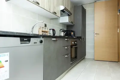 a kitchen with a sink and a stove at Luxurious and comfortable in Prestigia in Rabat