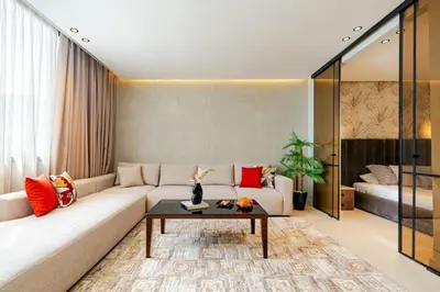 a living room with a couch and a table at Corniche Guest idéal pour un séjour Inoubliable in Casablanca