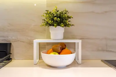 a bowl of fruit on a table with a plant at Corniche Guest idéal pour un séjour Inoubliable in Casablanca