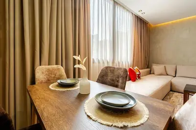 a living room with a table and a couch at Corniche Guest idéal pour un séjour Inoubliable in Casablanca