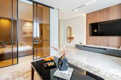 a living room with a television and a bed at Corniche Guest idéal pour un séjour Inoubliable in Casablanca