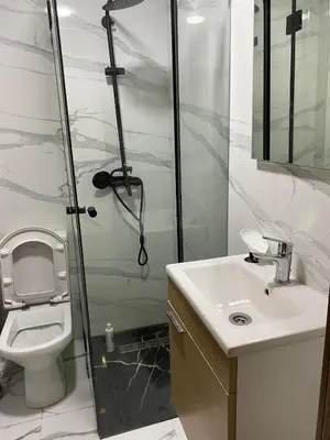 a bathroom with a shower and a toilet and a sink at Appt 1 ch meublé CFC TO CLOSE in Casablanca