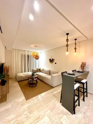 a living room with a couch and a table at Charming studio located in Tadart in Casablanca
