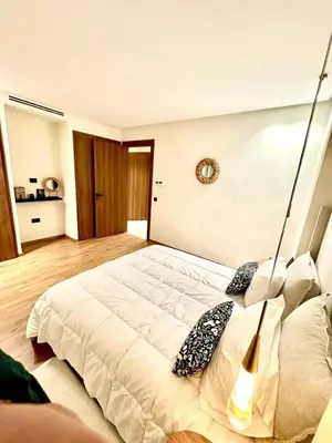 a bedroom with a large white bed in a room at Charming studio located in Tadart in Casablanca