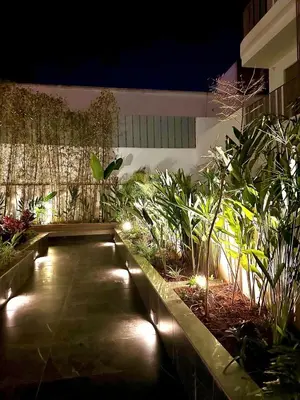 a garden with plants and lights in a building at Charming studio located in Tadart in Casablanca