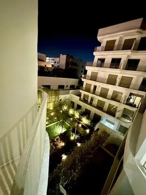 a view from the balcony of a building at night at Charming studio located in Tadart in Casablanca