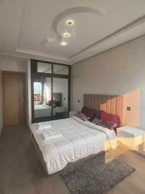 a bedroom with a large bed and a large window at Dar al bahr in Rabat