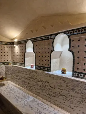 a room with two archways in a tile wall at Palm Palace Bouznika in Bouznika