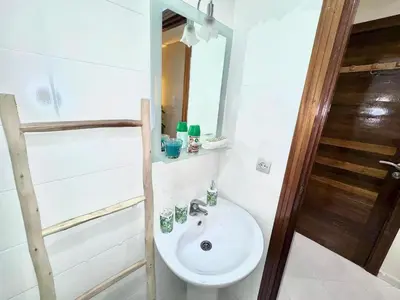 a bathroom with a sink and a mirror at cosy studio au cœur de rabat agdal in Rabat
