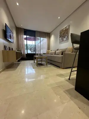 a living room with a couch and a table at Résidence Signature Leving in Maarif