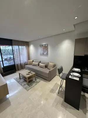 a living room with a couch and a table at Résidence Signature Leving in Maarif