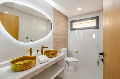 a bathroom with a wooden sink and a mirror at Charming Villa in Harhoura in Temara