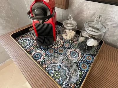 a table with wine glasses and a blender on it at Charming Villa in Harhoura in Temara