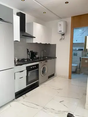 a kitchen with a stove and a washing machine at Appartement in Casablanca