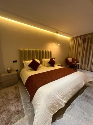 a bedroom with a large bed with a large white blanket at Deux studios luxueux à palmiers Casablanca in Casablanca