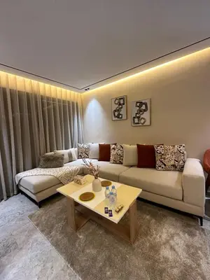 a living room with a couch and a coffee table at Deux studios luxueux à palmiers Casablanca in Casablanca