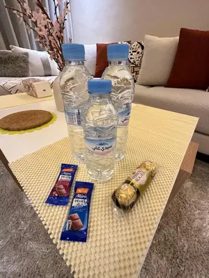 two bottles of water and two snacks on a table at Deux studios luxueux à palmiers Casablanca in Casablanca