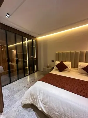 a bedroom with a large bed and a shower at Deux studios luxueux à palmiers Casablanca in Casablanca