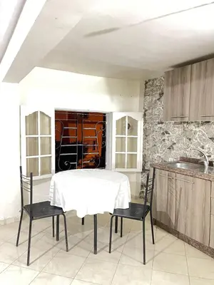 a dining room with a table and chairs in a kitchen at Maison in Mohammedia